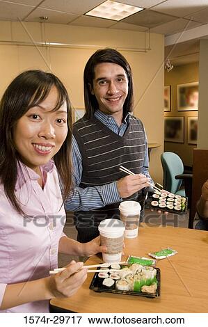 Portrait of friends sitting together and eating food View Large Photo Image Stock Photo - Portrait of friends sitting together and eating food. Fotosearch