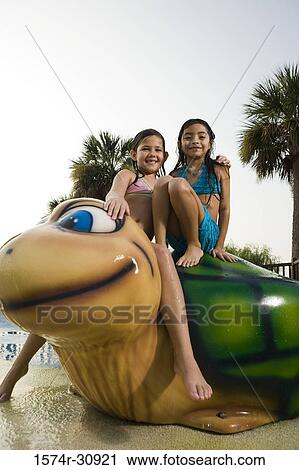 Portrait of girls sitting together on a tortoise sculpture View Large Photo Image Stock Image - Portrait of girls sitting together on a tortoise sculpture. Fotosearch