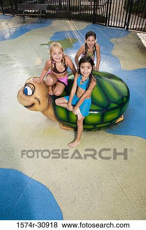 Portrait of girls sitting together on a tortoise sculpture View Large Photo Image Stock Photo - Portrait of girls sitting together on a tortoise sculpture. Fotosearch