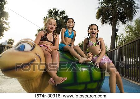 Portrait of girls sitting together on a tortoise sculpture View Large Photo Image Stock Photograph - Portrait of girls sitting together on a tortoise sculpture. Fotosearch