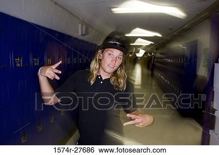 Portrait of male student standing by lockers View Large Photo Image Stock Photograph - Portrait of male student standing by lockers. Fotosearch