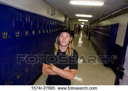 Portrait of male student standing by lockers View Large Photo Image Stock Photography - Portrait of male student standing by lockers. Fotosearch