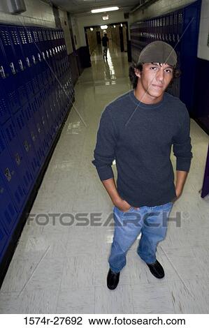Portrait of male student with hands in pockets standing by lockers View Large Photo Image Stock Image - Portrait of male student with hands in pockets standing by lockers. Fotosearch