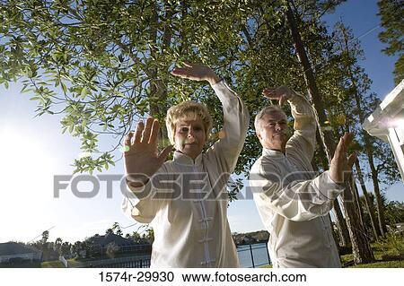 Portrait of mature couple practicing martial arts View Large Photo Image Stock Image - Portrait of mature couple practicing martial arts. Fotosearch