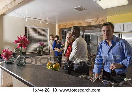 Portrait of men embracing women in domestic kitchen View Large Photo Image Stock Photo - Portrait of men embracing women in domestic kitchen. Fotosearch