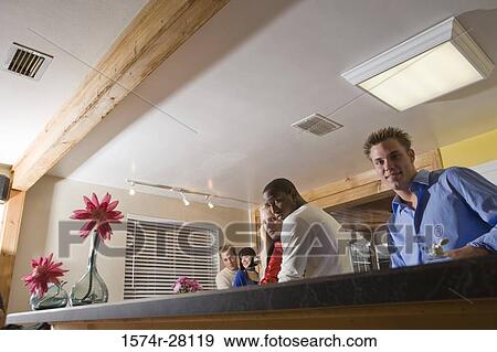 Portrait of men embracing women in domestic kitchen View Large Photo Image Stock Photo - Portrait of men embracing women in domestic kitchen. Fotosearch