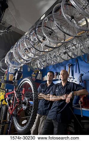 Portrait of men smiling in a workshop View Large Photo Image Stock Image - Portrait of men smiling in a workshop. Fotosearch