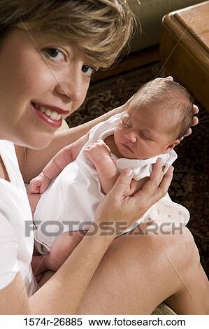 Portrait of mid adult woman holding her baby in hands View Large Photo Image Stock Photography - Portrait of mid adult woman holding her baby in hands. Fotosearch