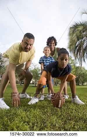 Portrait of parents playing with their children at park View Large Photo Image Stock Image - Portrait of parents playing with their children at park. Fotosearch