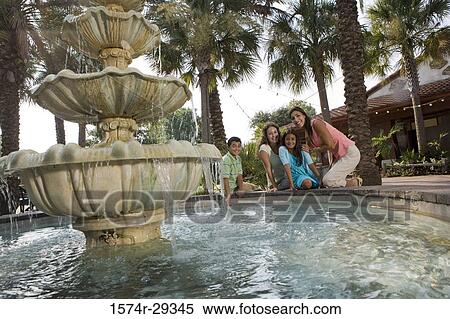 Portrait of people sitting together by a water fountain View Large Photo Image Stock Photography - Portrait of people sitting together by a water fountain. Fotosearch