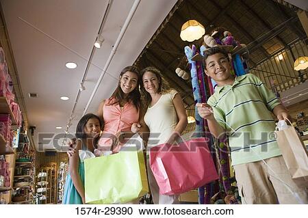 Portrait of people standing together in store with shopping bags View Large Photo Image Stock Image - Portrait of people standing together in store with shopping bags. Fotosearch