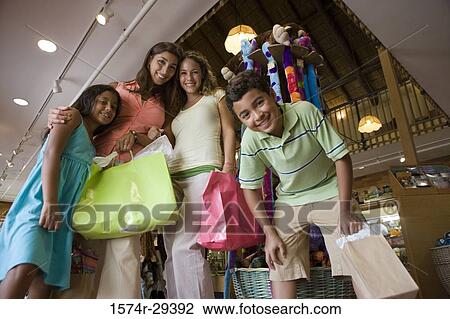Portrait of people standing together in store View Large Photo Image Stock Image - Portrait of people standing together in store. Fotosearch
