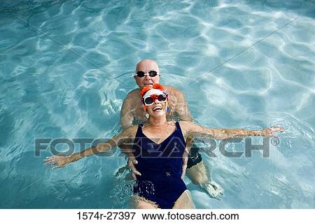 Portrait of senior couple swimming in swimming pool View Large Photo Image Stock Photo - Portrait of senior couple swimming in swimming pool. Fotosearch