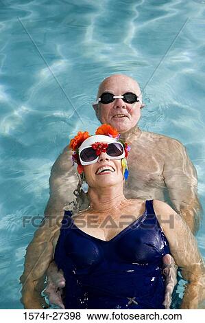 Portrait of senior couple swimming in swimming pool View Large Photo Image Stock Photo - Portrait of senior couple swimming in swimming pool. Fotosearch