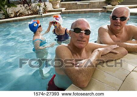 Portrait of senior men while senior women smiling in swimming pool View Large Photo Image Stock Image - Portrait of senior men while senior women smiling in swimming pool. Fotosearch