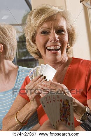 Portrait of senior women playing poker with her friends View Large Photo Image Stock Photo - Portrait of senior women playing poker with her friends. Fotosearch