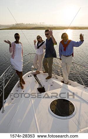 Portrait of smiling friends waving on the deck of a boat View Large Photo Image Stock Image - Portrait of smiling friends waving on the deck of a boat. Fotosearch