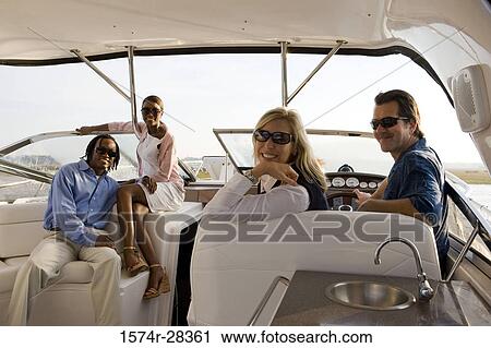 Portrait of smiling mid adult couples sitting in the boat View Large Photo Image Stock Image - Portrait of smiling mid adult couples sitting in the boat. Fotosearch