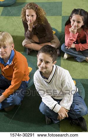 Portrait of smiling students sitting on floor in the library View Large Photo Image Stock Image - Portrait of smiling students sitting on floor in the library. Fotosearch
