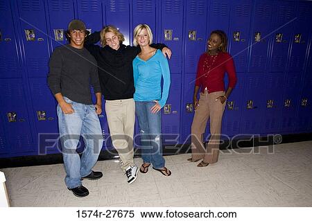 Portrait of students with female teacher smiling and standing by lockers View Large Photo Image Stock Photography - Portrait of students with female teacher smiling and standing by lockers. Fotosearch