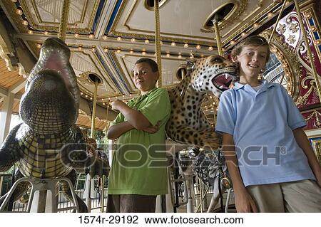 Portrait of teenage boys standing in a carousel by a carousel leopard View Large Photo Image Stock Image - Portrait of teenage boys standing in a carousel by a carousel leopard. Fotosearch