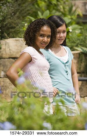 Portrait of teenage girls standing together View Large Photo Image Stock Image - Portrait of teenage girls standing together. Fotosearch