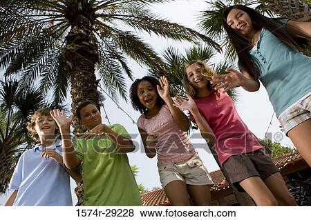 Portrait of teenagers dancing under a palm tree View Large Photo Image Stock Photo - Portrait of teenagers dancing under a palm tree. Fotosearch