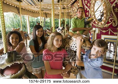 Portrait of teenagers standing in a carousel View Large Photo Image Stock Photography - Portrait of teenagers standing in a carousel. Fotosearch