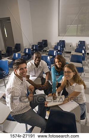 Stock Image - Portrait of university students smiling in the classroom. Fotosearch