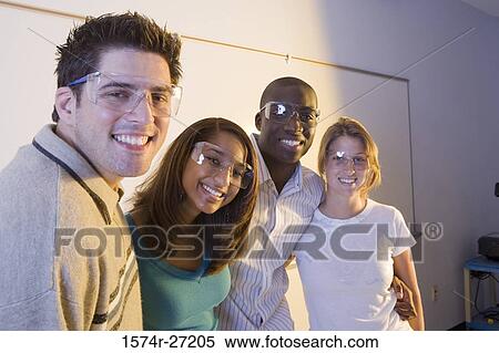 Portrait of university students wearing protective eyewear and smiling View Large Photo Image Stock Photography - Portrait of university students wearing protective eyewear and smiling. Fotosearch