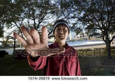 Portrait of young businessman with arms raised at park View Large Photo Image Stock Photo - Portrait of young businessman with arms raised at park. Fotosearch