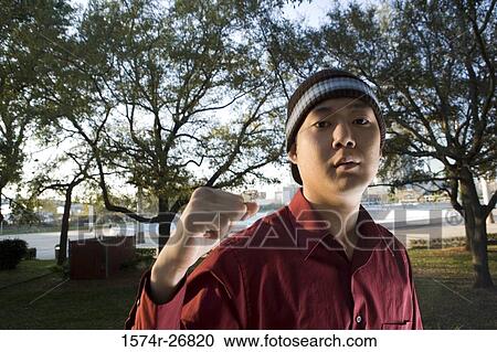 Portrait of young businessman with clenched fist at park View Large Photo Image Stock Image - Portrait of young businessman with clenched fist at park. Fotosearch