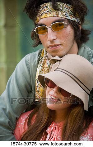 Stock Photography - Portrait of young man standing with her sister. Fotosearch