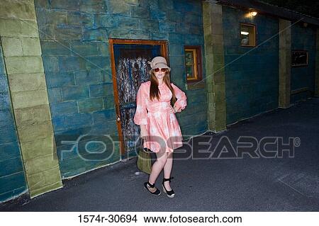 Portrait of young woman stand with her hand on hip View Large Photo Image Picture - Portrait of young woman stand with her hand on hip. Fotosearch