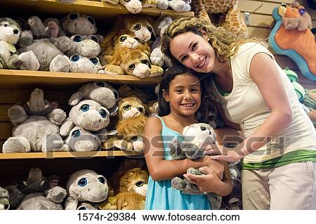 Portrait of young woman with daughter holding toy View Large Photo Image Picture - Portrait of young woman with daughter holding toy. Fotosearch
