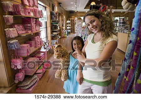 Portrait of young woman with daughter holding toy View Large Photo Image Stock Photo - Portrait of young woman with daughter holding toy. Fotosearch