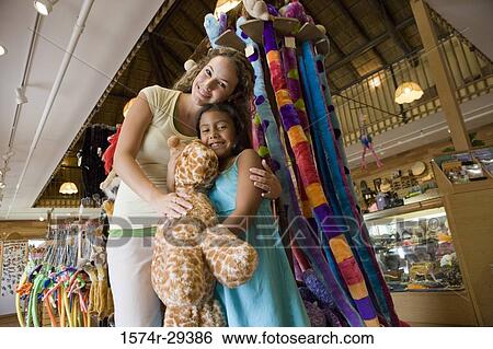 Portrait of young woman with daughter holding toy View Large Photo Image Stock Photograph - Portrait of young woman with daughter holding toy. Fotosearch