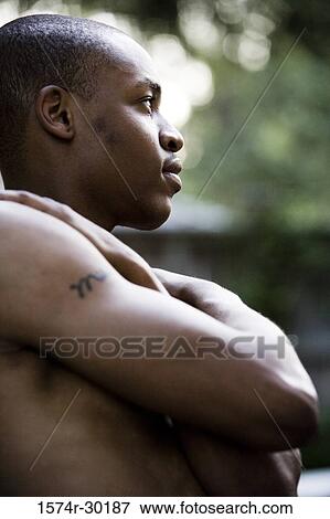 Stock Photo - Profile of a shirtless young man looking away. Fotosearch
