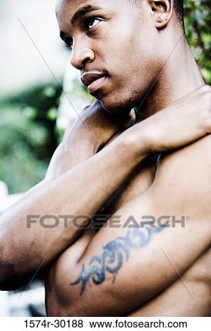 Profile of a shirtless young man looking away View Large Photo Image Stock Photo - Profile of a shirtless young man looking away. Fotosearch