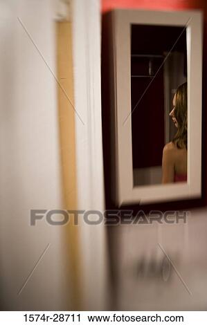 Stock Image - Reflection of a young prostitute in a mirror. Fotosearch