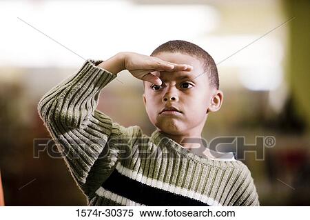 Stock Photography - Schoolboy in pullover saluting. Fotosearch