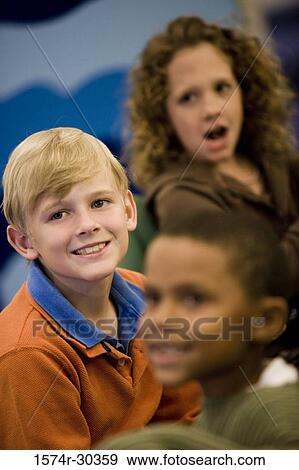 Stock Photo - Schoolboy smiling and looking away. Fotosearch