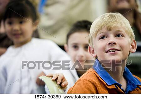Stock Photo - Schoolboy smiling and looking up. Fotosearch