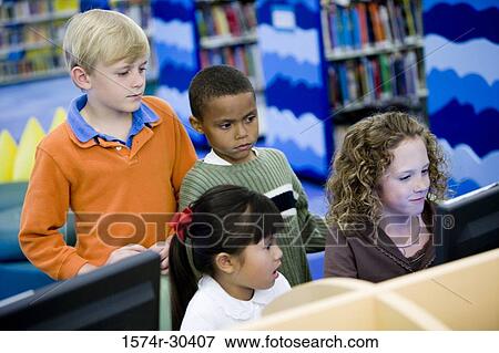 Schoolboys and girls using computer in the library View Large Photo Image Stock Photo - Schoolboys and girls using computer in the library. Fotosearch