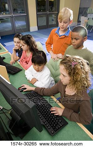 Schoolboys and girls using computer in the library View Large Photo Image Stock Photography - Schoolboys and girls using computer in the library. Fotosearch
