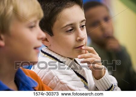 Schoolboys sitting side by side View Large Photo Image Stock Image - Schoolboys sitting side by side. Fotosearch