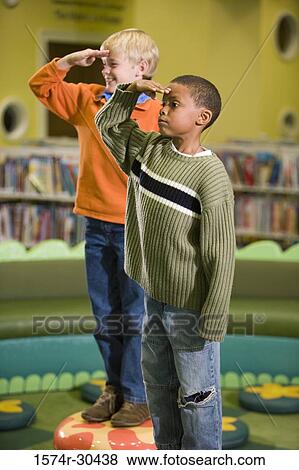 Schoolboys standing on stools and saluting View Large Photo Image Stock Photo - Schoolboys standing on stools and saluting. Fotosearch