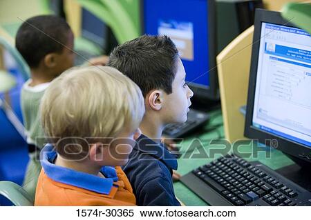 Schoolboys using computers in the library View Large Photo Image Stock Photography - Schoolboys using computers in the library. Fotosearch
