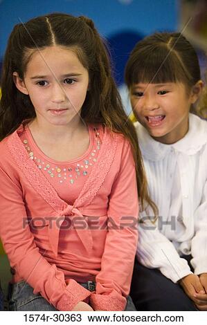 Schoolgirls smiling and looking away View Large Photo Image Stock Image - Schoolgirls smiling and looking away. Fotosearch