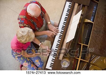 Stock Image - Senior couple playing piano. Fotosearch